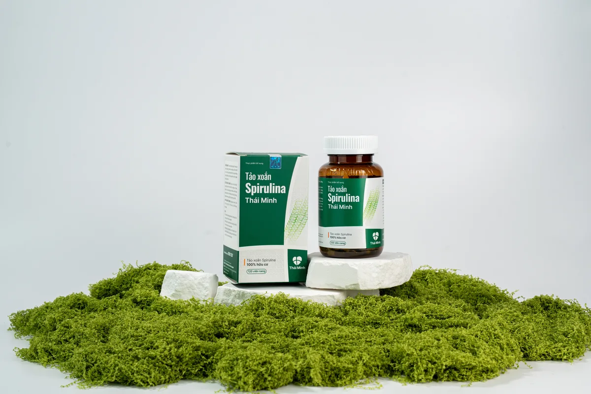 Hộp và lọ Tảo xoắn Spirulina Thái Minh đặt trên nền rêu xanh